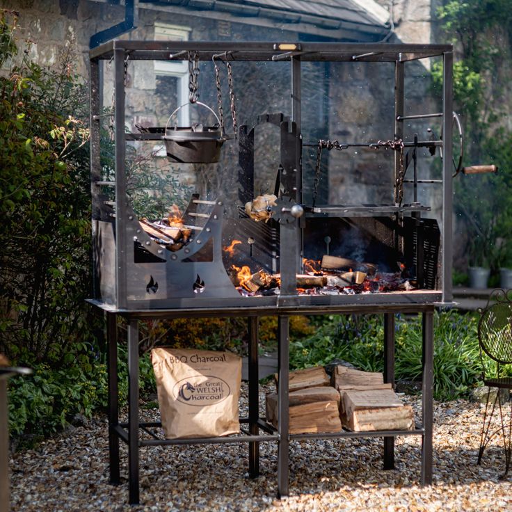 Argentinean Asado Grill, with wood smoking underneath grill plate 