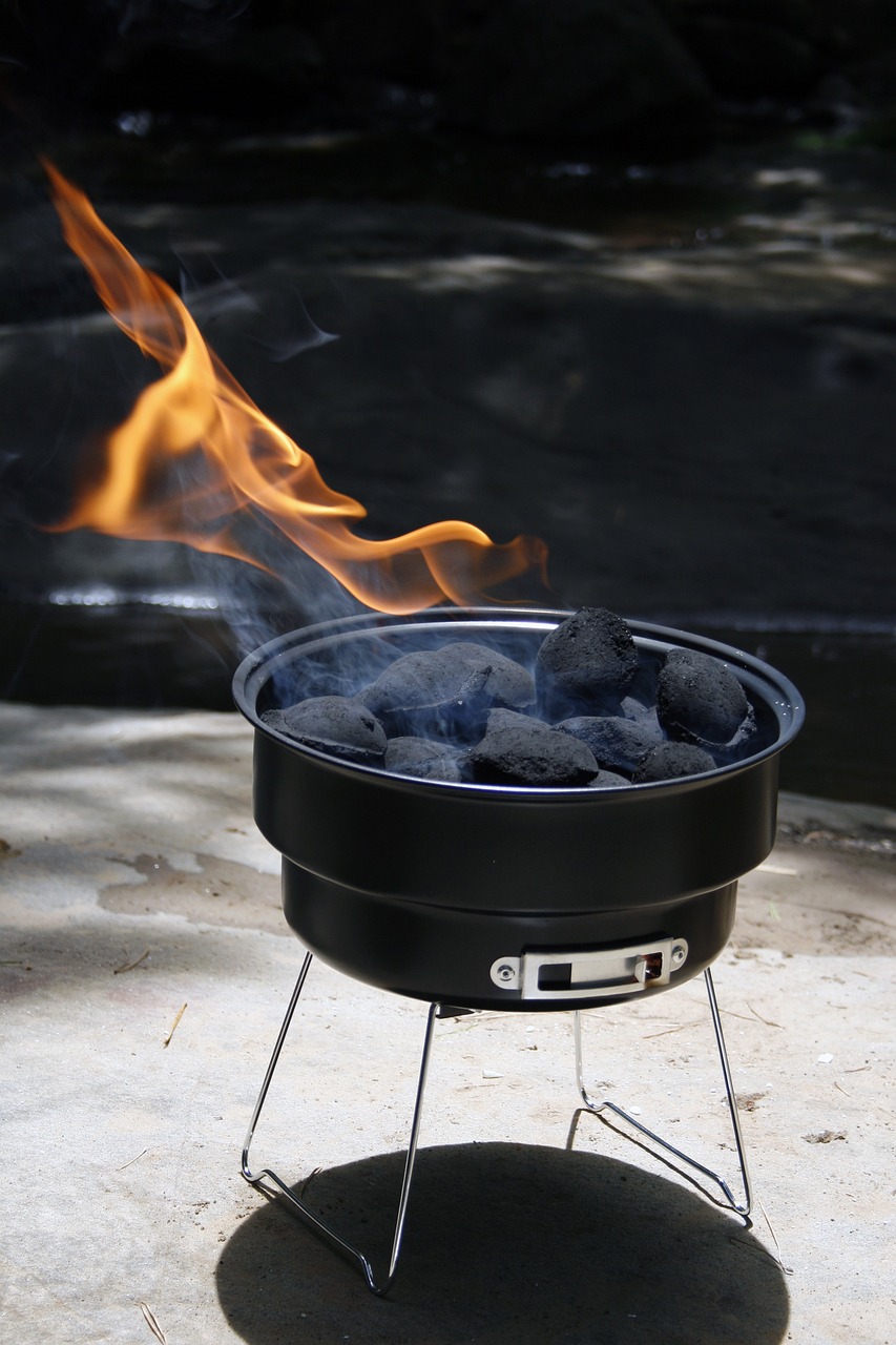 Image og a bbq with charcoals that have been site, not in the presence of lighter fluid